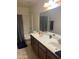 Bathroom vanity with double sinks, large mirror and tile flooring at 19427 N Toya St, Maricopa, AZ 85138