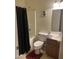 Well-lit bathroom with shower-tub combo, dark wood vanity, and single sink at 19427 N Toya St, Maricopa, AZ 85138