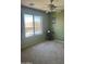 A simple bedroom with green walls and a view outside at 19427 N Toya St, Maricopa, AZ 85138
