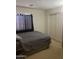 Cozy bedroom featuring plush carpeting, dark grey bedding, and a window with curtains at 19427 N Toya St, Maricopa, AZ 85138