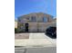 Two-story home featuring a well-manicured front yard, neutral color palette, and attached two-car garage at 19427 N Toya St, Maricopa, AZ 85138