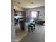 Modern kitchen with stainless steel appliances, center island, and wood cabinetry with breakfast bar seating at 19427 N Toya St, Maricopa, AZ 85138