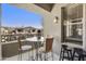 A cozy balcony with great views, a glass table, and a decorative outdoor lantern at 19475 N Grayhawk Dr # 2132, Scottsdale, AZ 85255