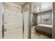 Bright bathroom with glass enclosed shower and access to the main bedroom at 19475 N Grayhawk Dr # 2132, Scottsdale, AZ 85255