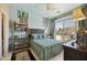 Comfortable bedroom with a ceiling fan, large window, and outdoor balcony at 19475 N Grayhawk Dr # 2132, Scottsdale, AZ 85255