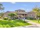 Welcoming community center featuring a tile roof, stone accents, and a manicured lawn at 19475 N Grayhawk Dr # 2132, Scottsdale, AZ 85255