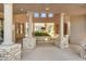 Elegant entrance featuring tall pillars, a stone base, and lush landscaping for a grand arrival at 19475 N Grayhawk Dr # 2132, Scottsdale, AZ 85255