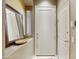 Foyer featuring a custom wood door, mirror and neutral paint at 19475 N Grayhawk Dr # 2132, Scottsdale, AZ 85255
