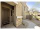 Front entrance showcasing a custom wood door, stone accents, and desert landscaping at 19475 N Grayhawk Dr # 2132, Scottsdale, AZ 85255
