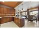 Spacious kitchen with granite countertops, wood cabinets, and adjacent dining and living areas at 19475 N Grayhawk Dr # 2132, Scottsdale, AZ 85255