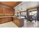 Spacious kitchen with granite countertops, wood cabinets, and adjacent dining and living areas at 19475 N Grayhawk Dr # 2132, Scottsdale, AZ 85255