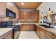 Well-lit kitchen features custom cabinets, mosaic tile backsplash, and granite countertops at 19475 N Grayhawk Dr # 2132, Scottsdale, AZ 85255