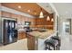 Modern kitchen with stainless steel appliances, granite countertops, and breakfast bar seating for casual dining at 19475 N Grayhawk Dr # 2132, Scottsdale, AZ 85255