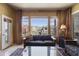 Relaxing living room features scenic backyard views through bright windows, and comfortable furniture at 19475 N Grayhawk Dr # 2132, Scottsdale, AZ 85255