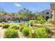 Community pool surrounded by mature trees and lush landscaping for a relaxing atmosphere at 19475 N Grayhawk Dr # 2132, Scottsdale, AZ 85255