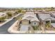 Attractive aerial view of a home featuring desert landscaping, a paved driveway, and a two-car garage at 23434 N 76Th Way, Scottsdale, AZ 85255