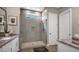Spacious bathroom boasting a large walk-in shower with glass door, tiled walls, and white cabinets at 23434 N 76Th Way, Scottsdale, AZ 85255