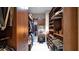 Walk-in closet with custom wood shelving, hanging rods, drawers, and vanity area providing ample storage at 23434 N 76Th Way, Scottsdale, AZ 85255
