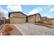 Beautiful home featuring a three-car garage, desert landscaping, and a paved driveway at 23434 N 76Th Way, Scottsdale, AZ 85255
