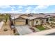 Charming home featuring a three-car garage, desert landscaping, and a beautifully paved driveway at 23434 N 76Th Way, Scottsdale, AZ 85255
