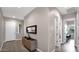 Bright hallway with a console table, mirror, and wood-look tile leading to the main living areas at 23434 N 76Th Way, Scottsdale, AZ 85255