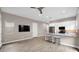 Open-concept living area features wood flooring, a ceiling fan, and great natural light at 23434 N 76Th Way, Scottsdale, AZ 85255