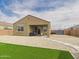 View of backyard featuring a covered patio, gravel landscaping, and artificial turf lawn at 235 S San Gregorio Ln, Casa Grande, AZ 85194
