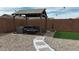 Relaxing backyard with covered patio, fire pit, comfortable furniture, and artificial turf lawn at 235 S San Gregorio Ln, Casa Grande, AZ 85194