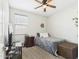 Cozy bedroom features a comfortable bed, ceiling fan, and natural light from the window at 235 S San Gregorio Ln, Casa Grande, AZ 85194