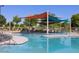 Community pool area with colorful sunshades offering a fun and shaded spot for relaxation and recreation at 235 S San Gregorio Ln, Casa Grande, AZ 85194