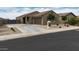 Charming home with a well-manicured front yard and a spacious driveway at 235 S San Gregorio Ln, Casa Grande, AZ 85194