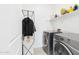 Clean laundry area boasts modern washer and dryer appliances with adjacent storage shelving at 235 S San Gregorio Ln, Casa Grande, AZ 85194