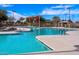 An inviting swimming pool with ample seating, shading, and well-manicured landscaping surrounds at 235 S San Gregorio Ln, Casa Grande, AZ 85194