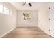 This bedroom is a blank canvas for customization, with neutral walls, wood-look flooring, and natural light at 2408 W Flower St, Phoenix, AZ 85015