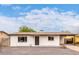 Charming single-story home with a fresh white exterior and a well-maintained gravel front yard at 2408 W Flower St, Phoenix, AZ 85015