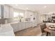 Bright, updated kitchen with white cabinets, modern appliances, and quartz countertops overlooking the living area at 2408 W Flower St, Phoenix, AZ 85015