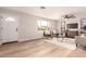 Open-concept living area featuring wood floors, a ceiling fan, and an abundance of natural light at 2408 W Flower St, Phoenix, AZ 85015