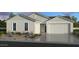 Charming single-story home featuring neutral-colored exterior, two-car garage, and drought-tolerant landscaping at 25123 N 171St Ave, Surprise, AZ 85387