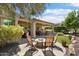 Relaxing backyard patio with a fire pit, built-in grill, outdoor seating, and lush landscaping at 27280 N Makena Pl, Peoria, AZ 85383
