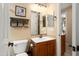 Charming bathroom with warm tones, showcasing a vanity and toilet with modern fixtures at 27280 N Makena Pl, Peoria, AZ 85383