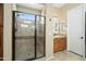 Modern bathroom featuring glass enclosed shower, tile floors, and granite countertop vanity at 27280 N Makena Pl, Peoria, AZ 85383