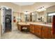 Spacious bathroom boasts tiled counters, dual sinks, makeup vanity, and a walk-in closet for convenient storage at 27280 N Makena Pl, Peoria, AZ 85383