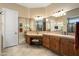 Spacious bathroom boasts tiled counters, dual sinks, and a makeup vanity with ample mirrored space at 27280 N Makena Pl, Peoria, AZ 85383