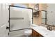 Functional bathroom featuring a tub with frosted glass doors, a toilet, and a vanity at 27280 N Makena Pl, Peoria, AZ 85383