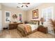 Serene bedroom featuring wood floors, shutters, and custom furnishings at 27280 N Makena Pl, Peoria, AZ 85383