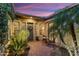 Cozy outdoor patio area with lush tropical plants, stylish furniture, and decorative string lights at 27280 N Makena Pl, Peoria, AZ 85383