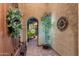 Charming courtyard entrance with stone pavers, decorative lighting, and an arched hallway at 27280 N Makena Pl, Peoria, AZ 85383