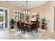 Elegant dining room with modern chandelier, plantation shutters, and stylish décor at 27280 N Makena Pl, Peoria, AZ 85383