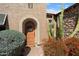 Inviting front entrance with a decorative wooden door, desert plants, and a stone-accented facade at 27280 N Makena Pl, Peoria, AZ 85383