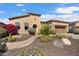 Charming home with desert landscaping, stone accents, and a well-maintained front yard under a clear blue sky at 27280 N Makena Pl, Peoria, AZ 85383